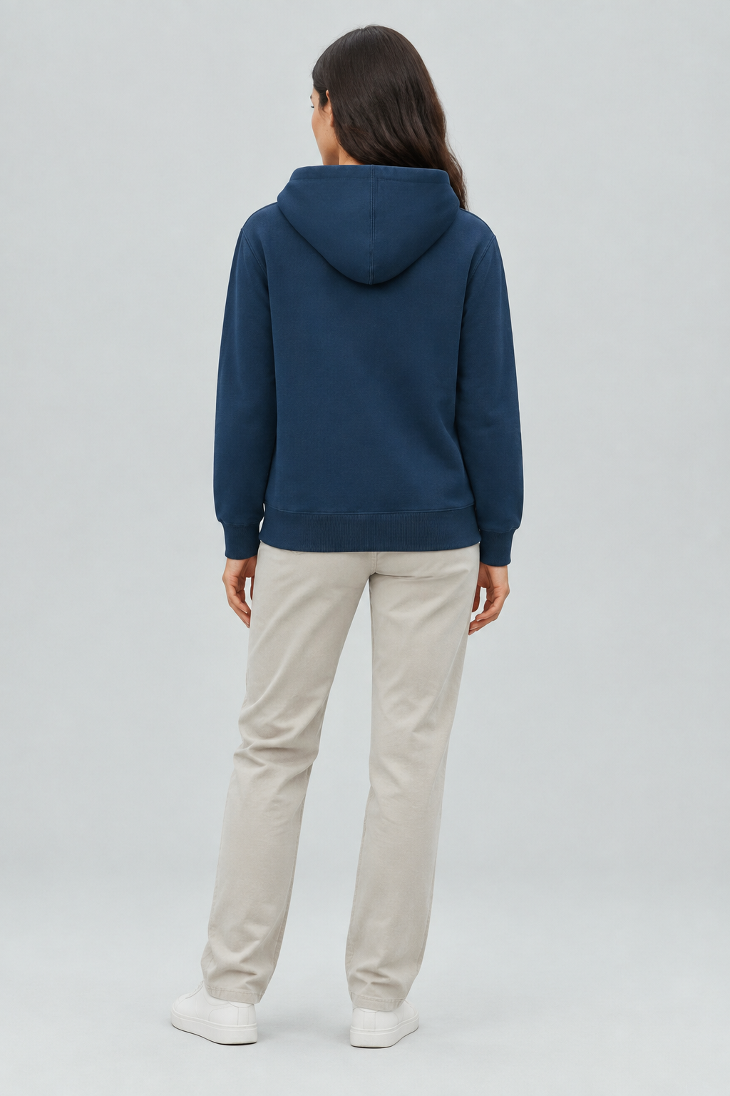 Brunette model wearing the navy hoodie from the back