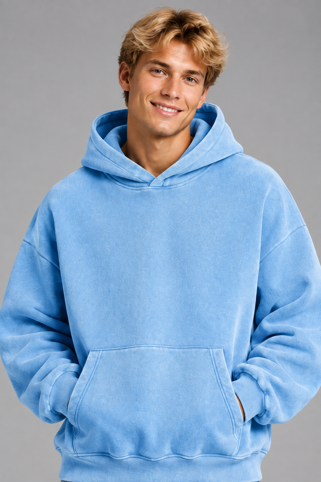 Close-up of the smiling blonde model wearing the hoodie