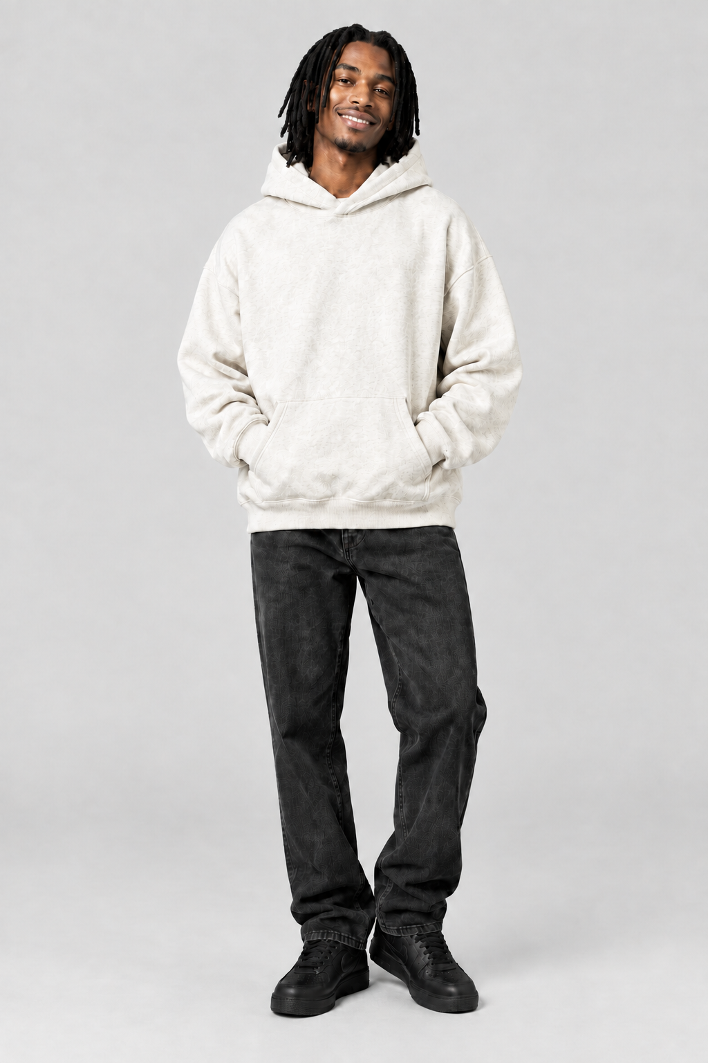 Smiling model wearing the hoodie in the same studio setup